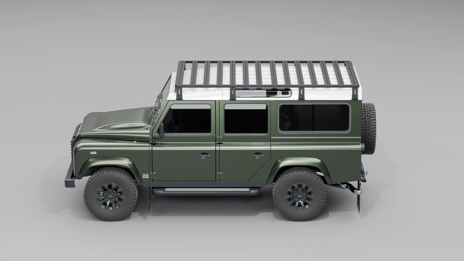 Seitenansicht: Schwarzer, modularer Dachträger montiert auf einem Land Rover Defender 110.